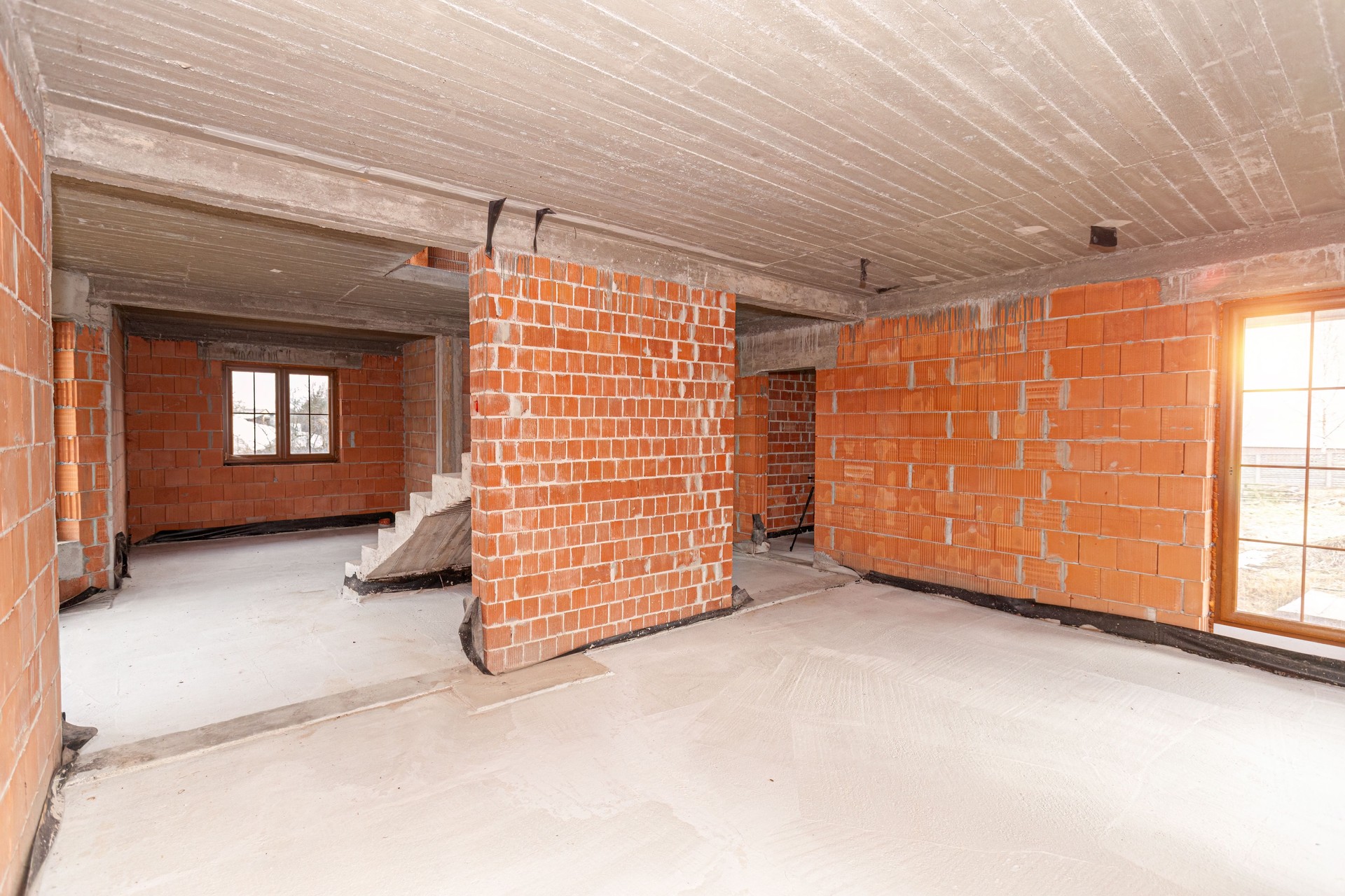 Unfinished construction inside red brick house not plastered
